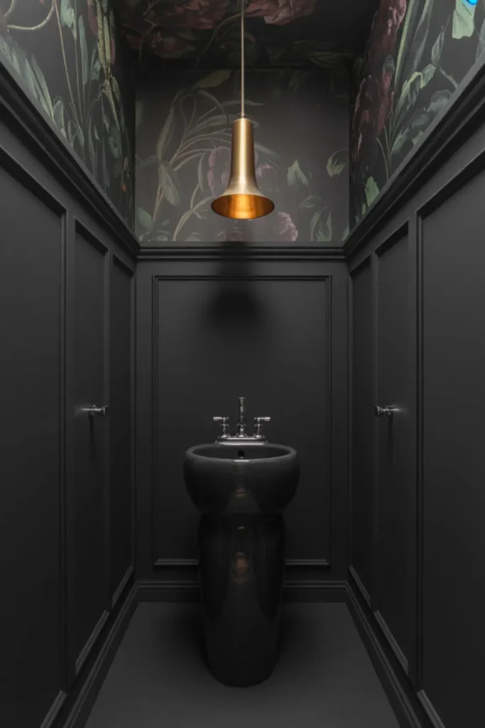  Dramatic all-black powder room with dark floral ceiling wallpaper.