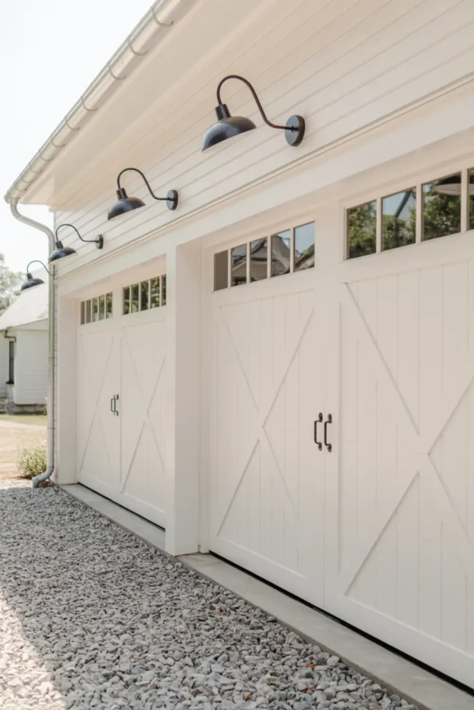White X-buck barn style garage doors on a modern farmhouse.